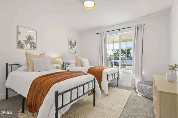 a bedroom with a large bed and a window