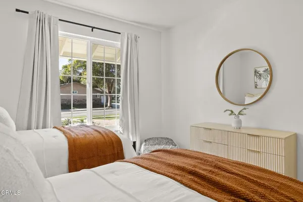 a bedroom with a bed and a potted plant