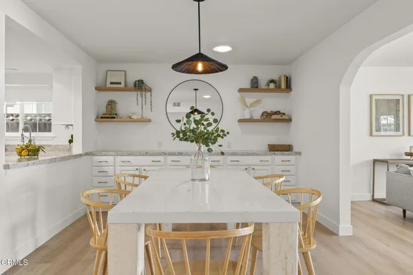 a dining room with furniture and window