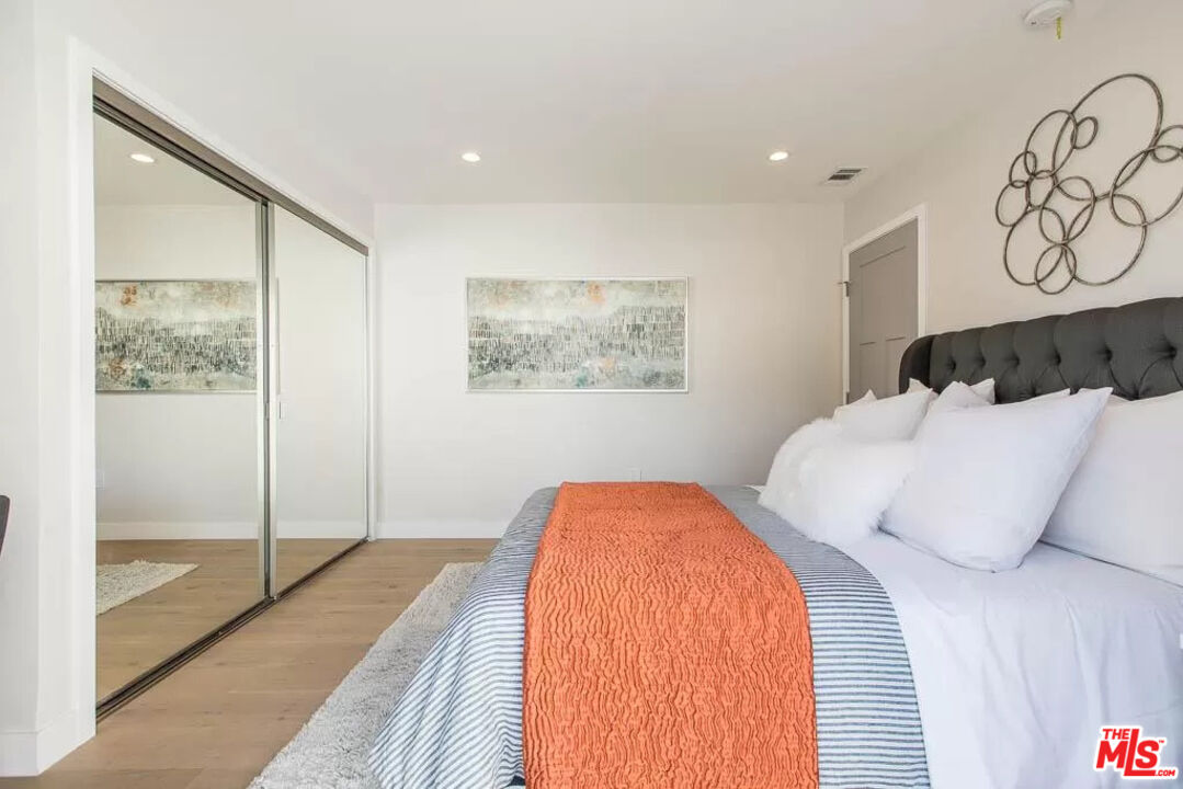 2419 Walnut Avenue Venice, CA 90291 - Photo 11 of 16 a bedroom with a large bed and a chandelier