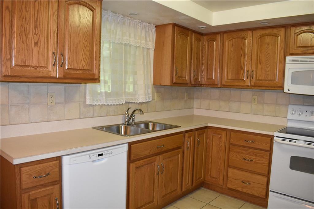 Fabulous kitchen with appliances, recess lights and ceramic floors.