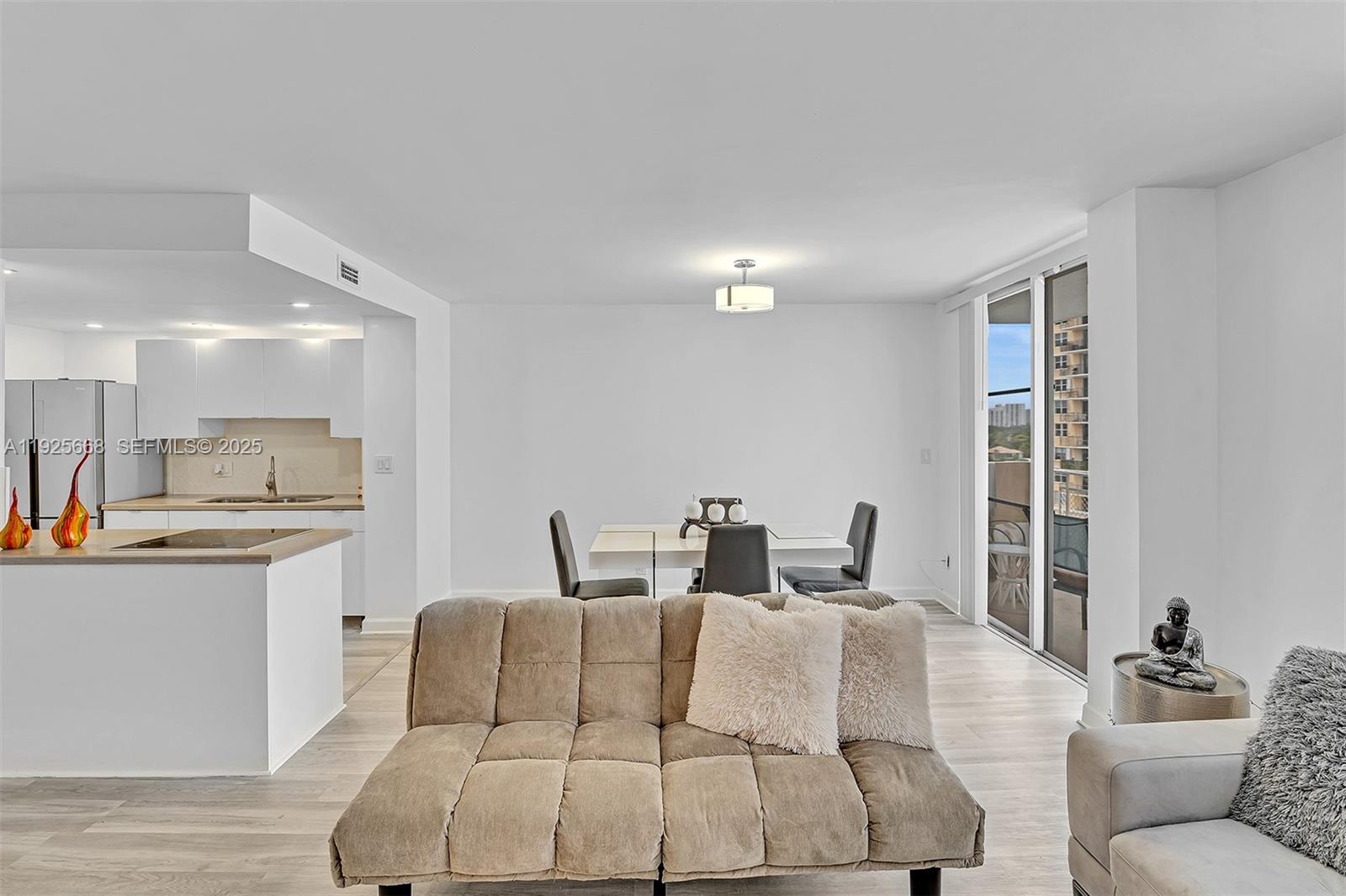 430 Golden Isles Drive, Unit 803 Hallandale Beach, FL 33009 - Photo 13 of 48 a living room with furniture and a large window
