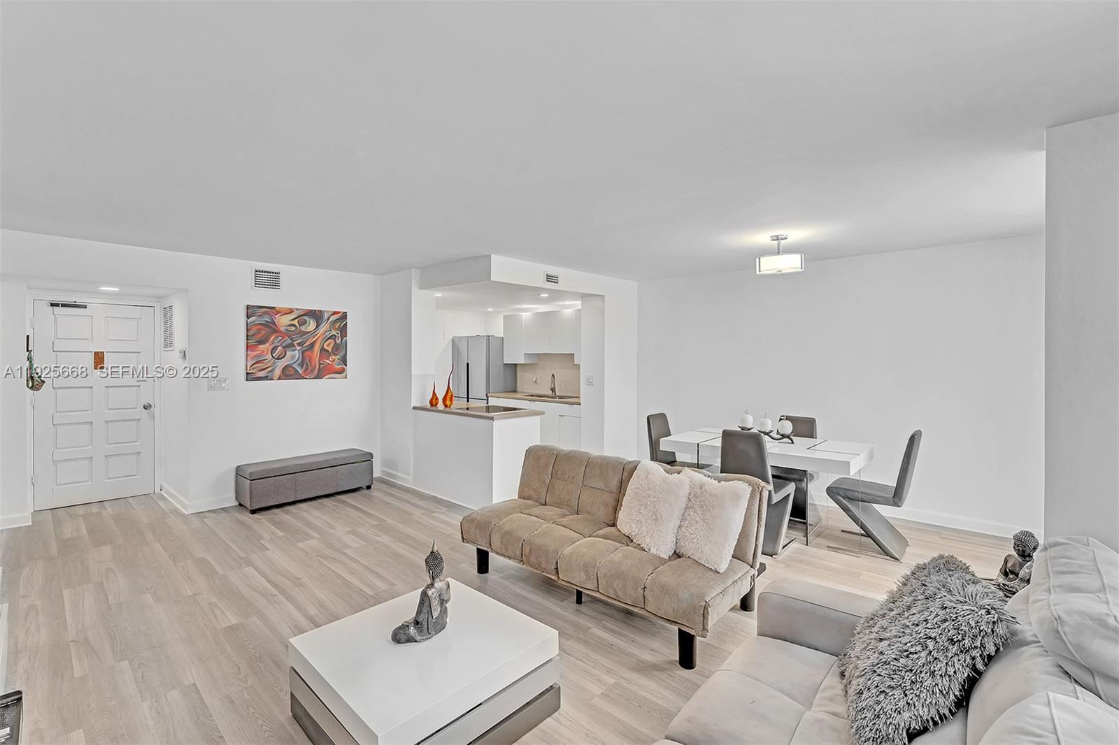 430 Golden Isles Drive, Unit 803 Hallandale Beach, FL 33009 - Photo 14 of 48 a living room with furniture and a wooden floor