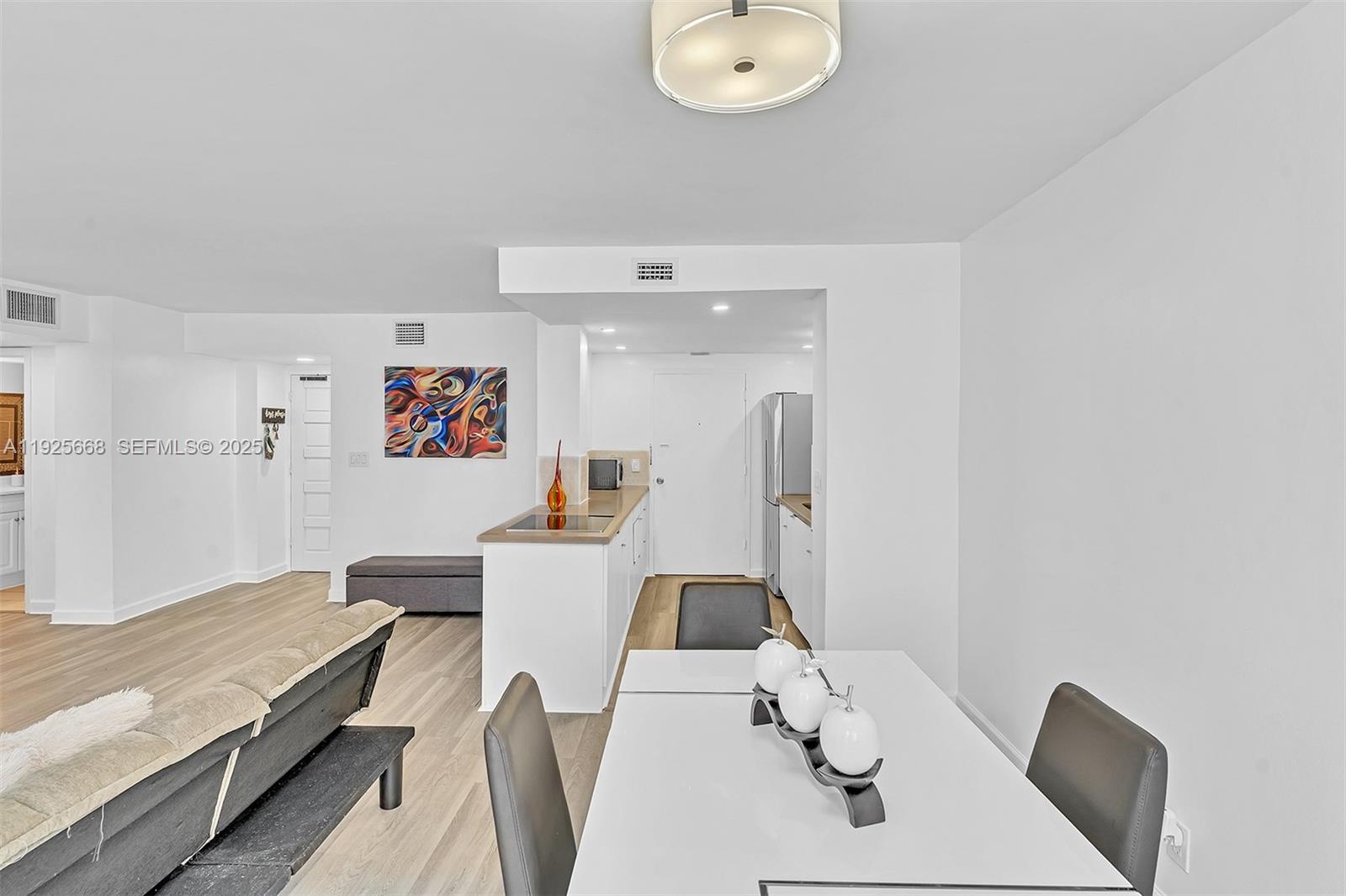 430 Golden Isles Drive, Unit 803 Hallandale Beach, FL 33009 - Photo 16 of 48 a living room with furniture and a table