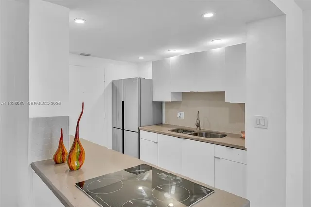 a kitchen with a sink appliances and a window
