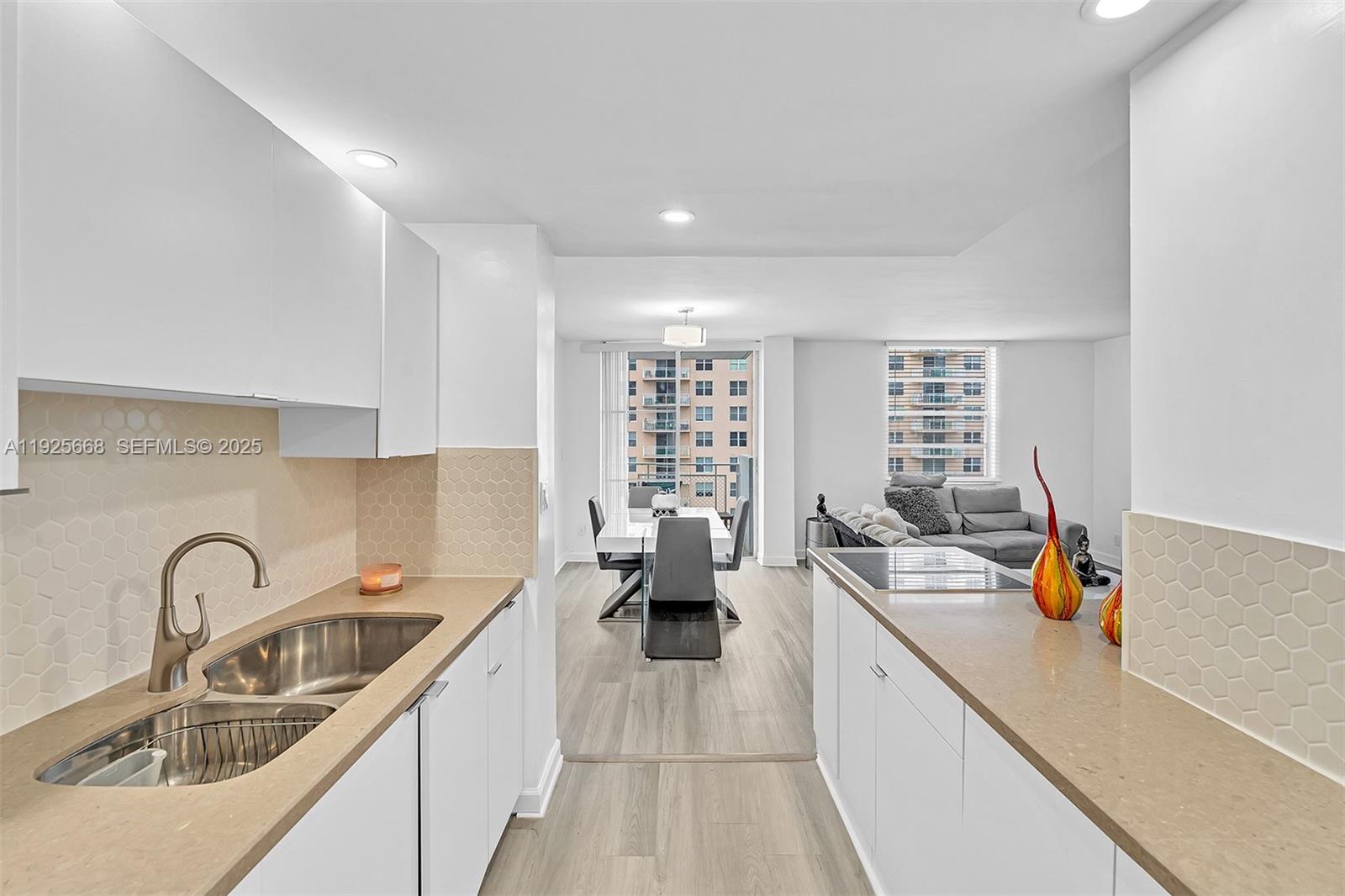 430 Golden Isles Drive, Unit 803 Hallandale Beach, FL 33009 - Photo 20 of 48 a kitchen with a sink appliances and a window