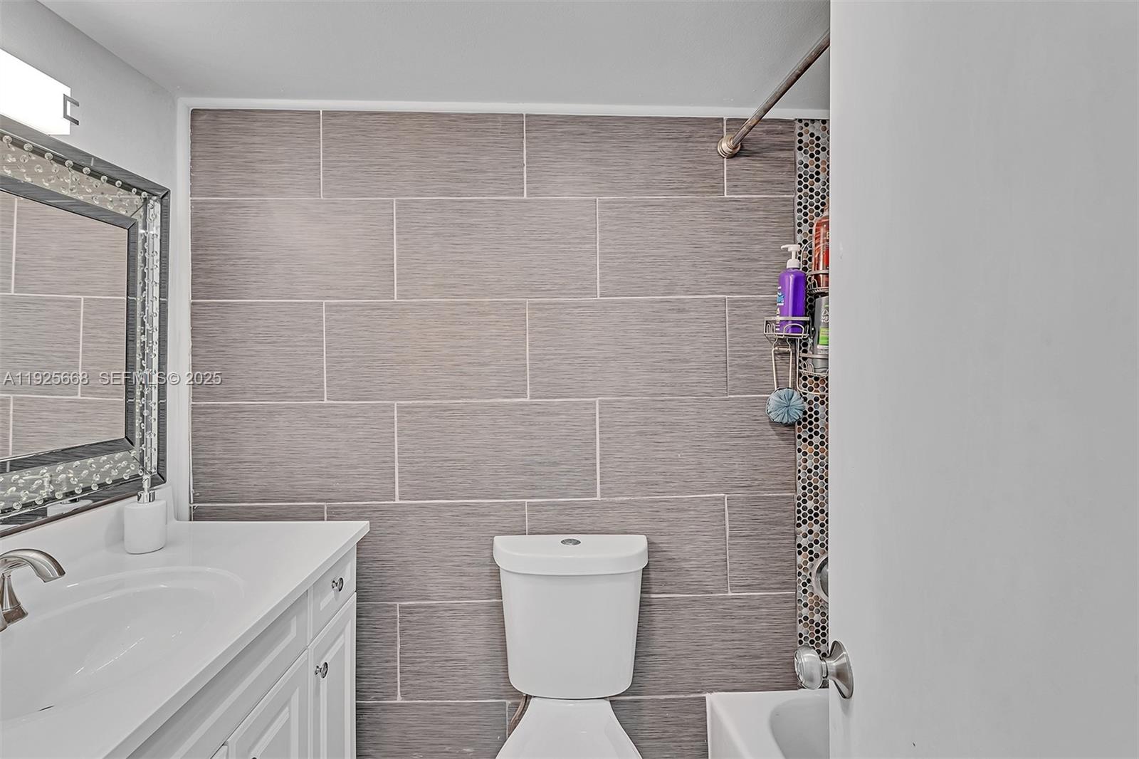 430 Golden Isles Drive, Unit 803 Hallandale Beach, FL 33009 - Photo 30 of 48 a bathroom with a sink toilet and shower