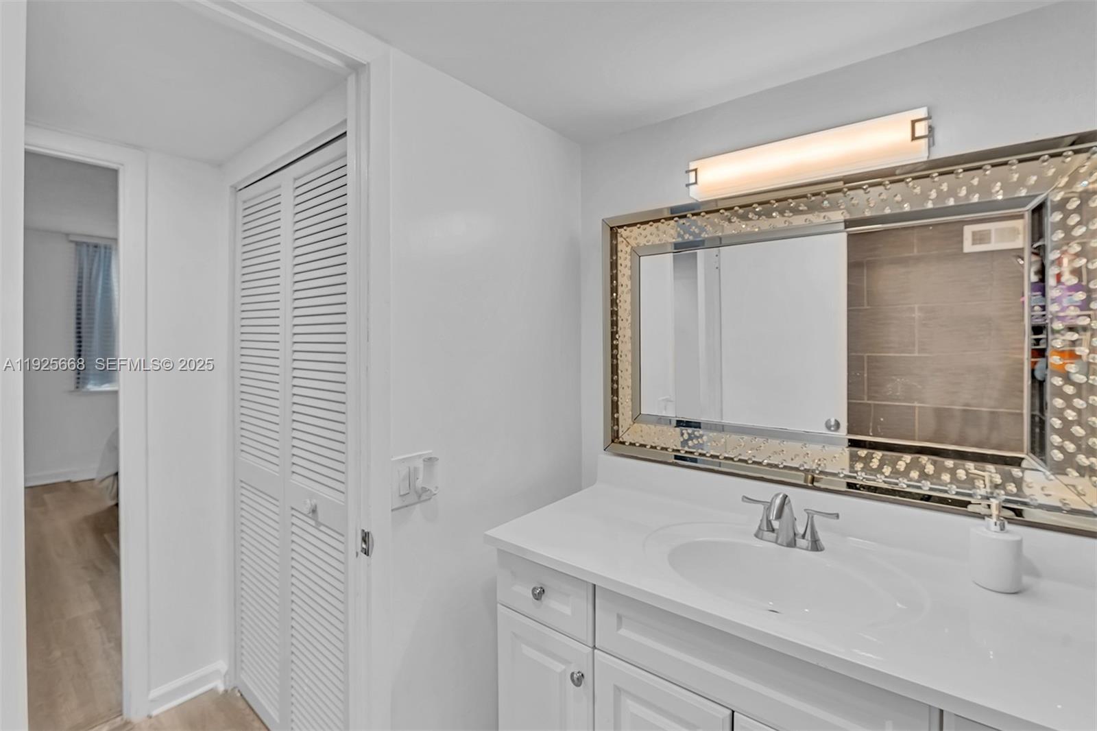 430 Golden Isles Drive, Unit 803 Hallandale Beach, FL 33009 - Photo 32 of 48 a bathroom with a sink and a mirror
