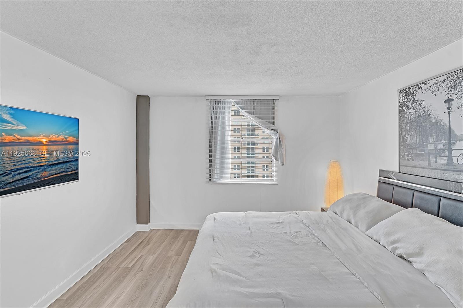 430 Golden Isles Drive, Unit 803 Hallandale Beach, FL 33009 - Photo 34 of 48 a bedroom with a bed and a window