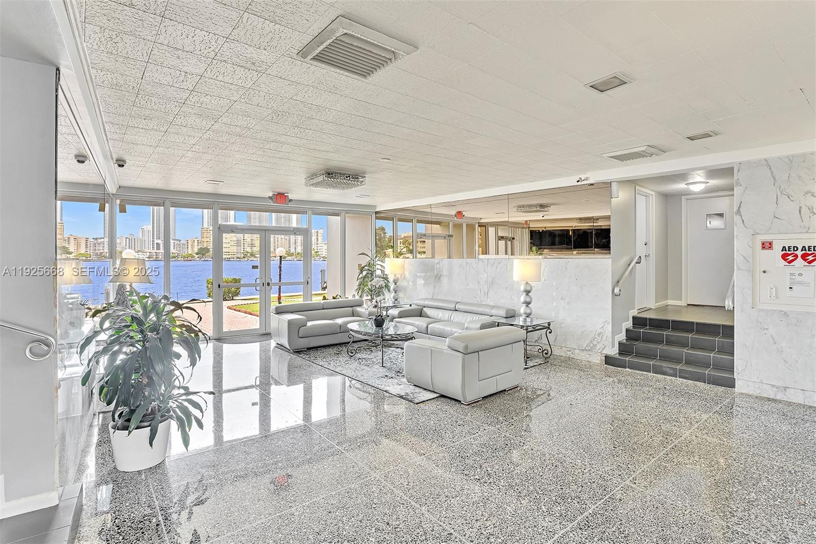 430 Golden Isles Drive, Unit 803 Hallandale Beach, FL 33009 - Photo 4 of 48 a living room with furniture and a table