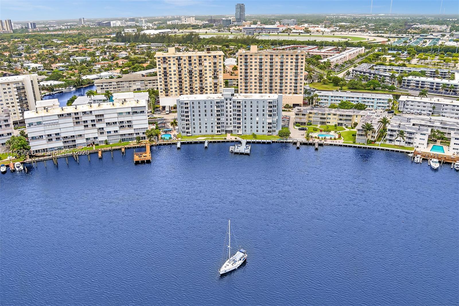 430 Golden Isles Drive, Unit 803 Hallandale Beach, FL 33009 - Photo 43 of 48 an aerial view of multiple houses with outdoor space