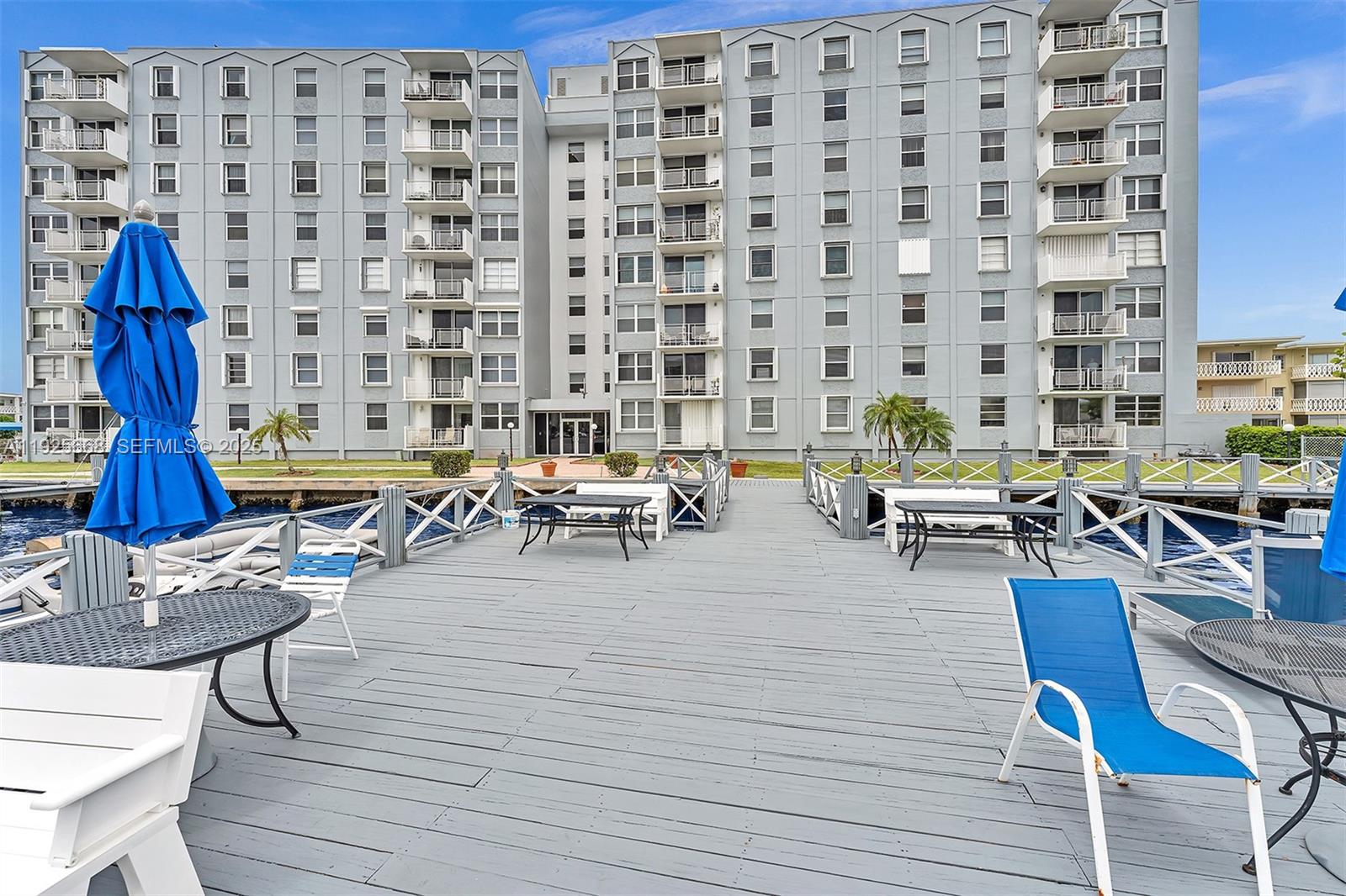 430 Golden Isles Drive, Unit 803 Hallandale Beach, FL 33009 - Photo 6 of 48 a living room with furniture and wooden floor