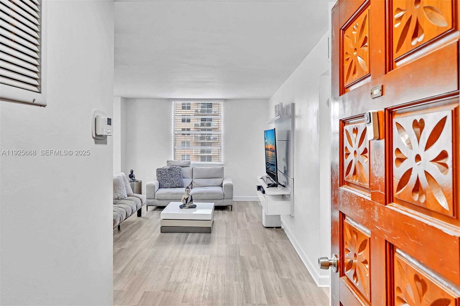 430 Golden Isles Drive, Unit 803 Hallandale Beach, FL 33009 - Photo 8 of 48 a living room with furniture and a wooden floor