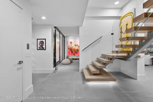 a view of hallway with stairs and furniture