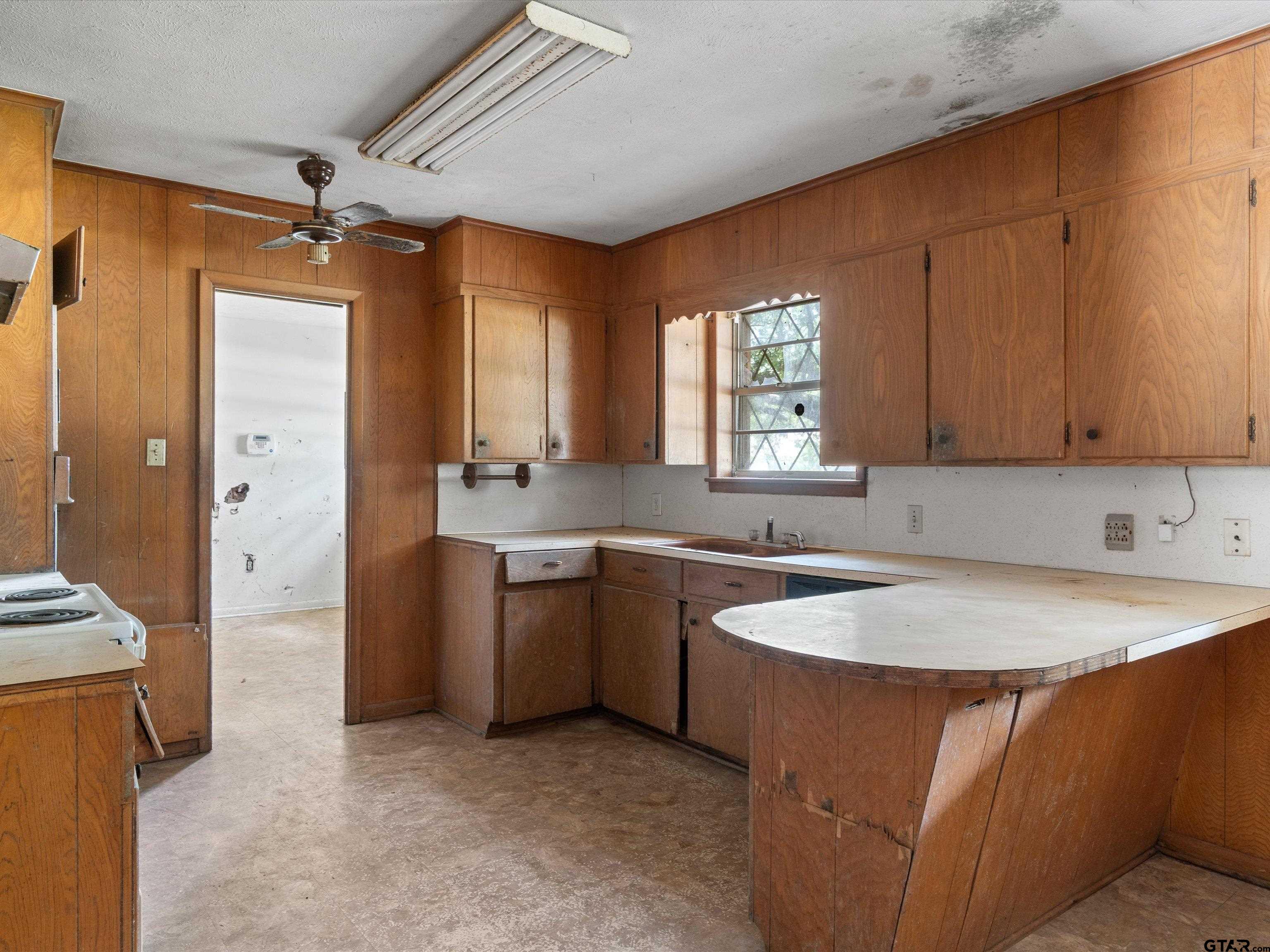 175 Stevens Street Gilmer, TX 75645 - Photo 15 of 25 a kitchen with stainless steel appliances granite countertop a sink stove and refrigerator