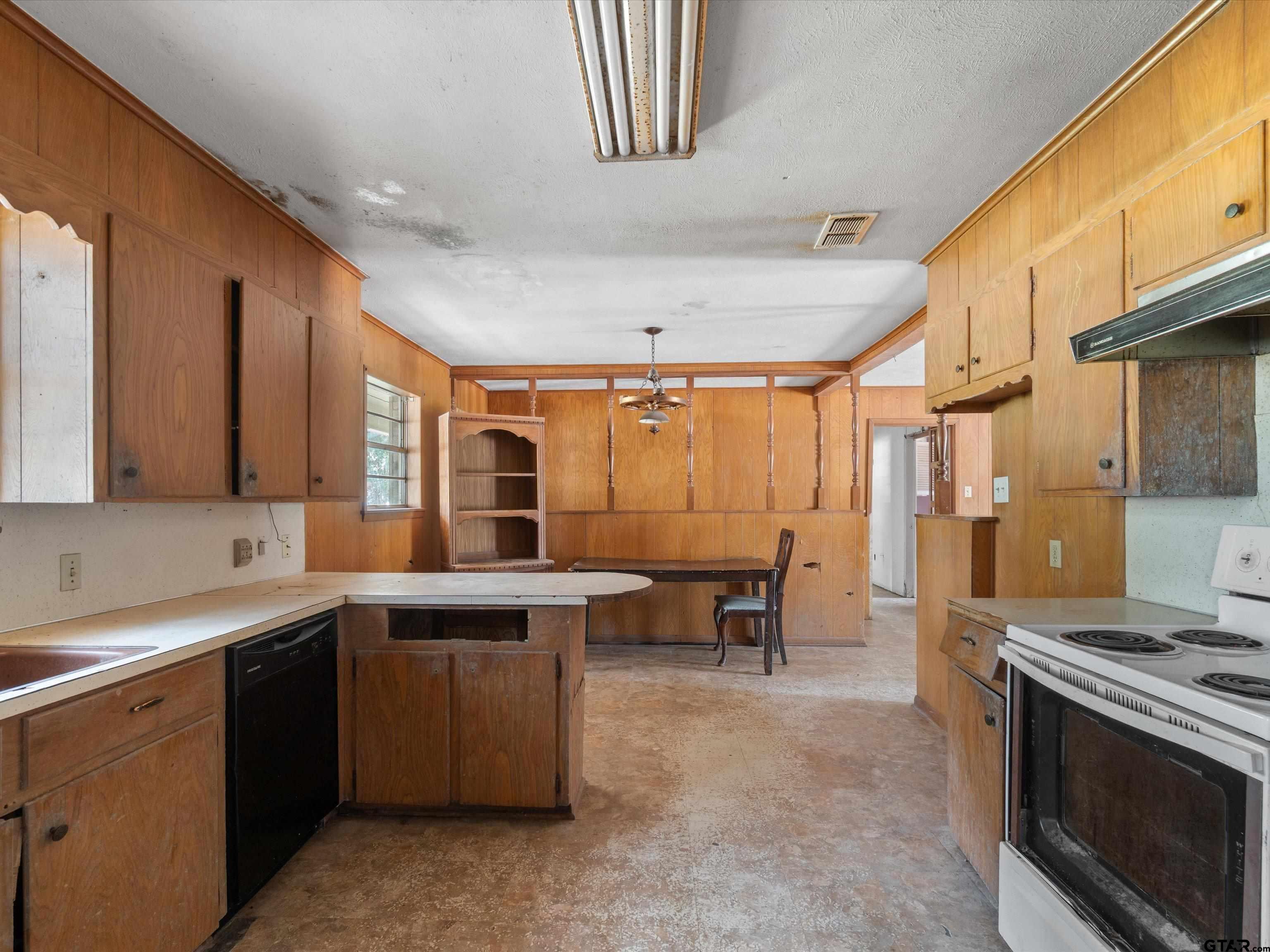 175 Stevens Street Gilmer, TX 75645 - Photo 17 of 25 a kitchen with a sink and a stove top oven