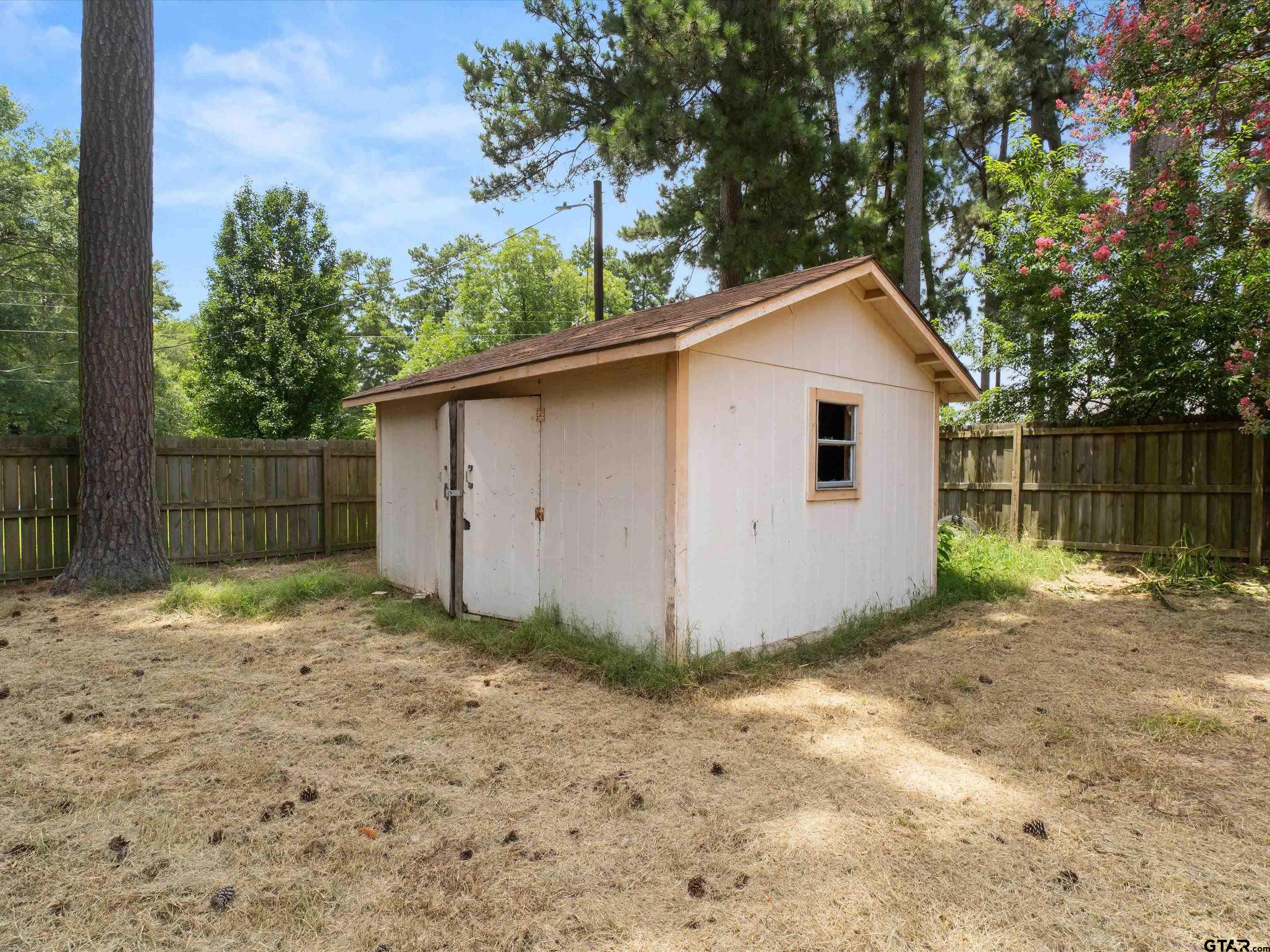 175 Stevens Street Gilmer, TX 75645 - Photo 24 of 25 a view of backyard of house with wooden fence
