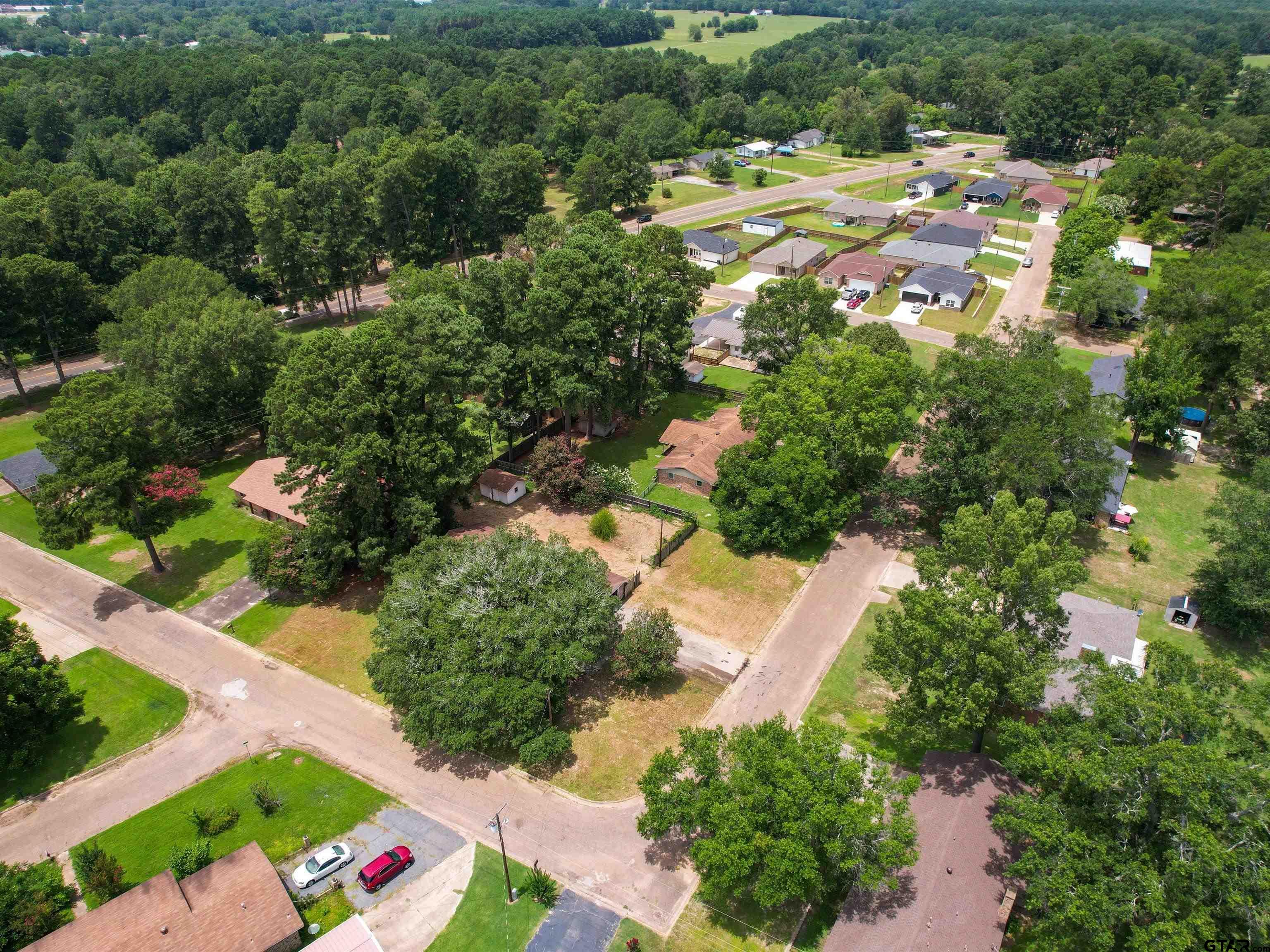 175 Stevens Street Gilmer, TX 75645 - Photo 5 of 25 an aerial view of residential houses with outdoor space