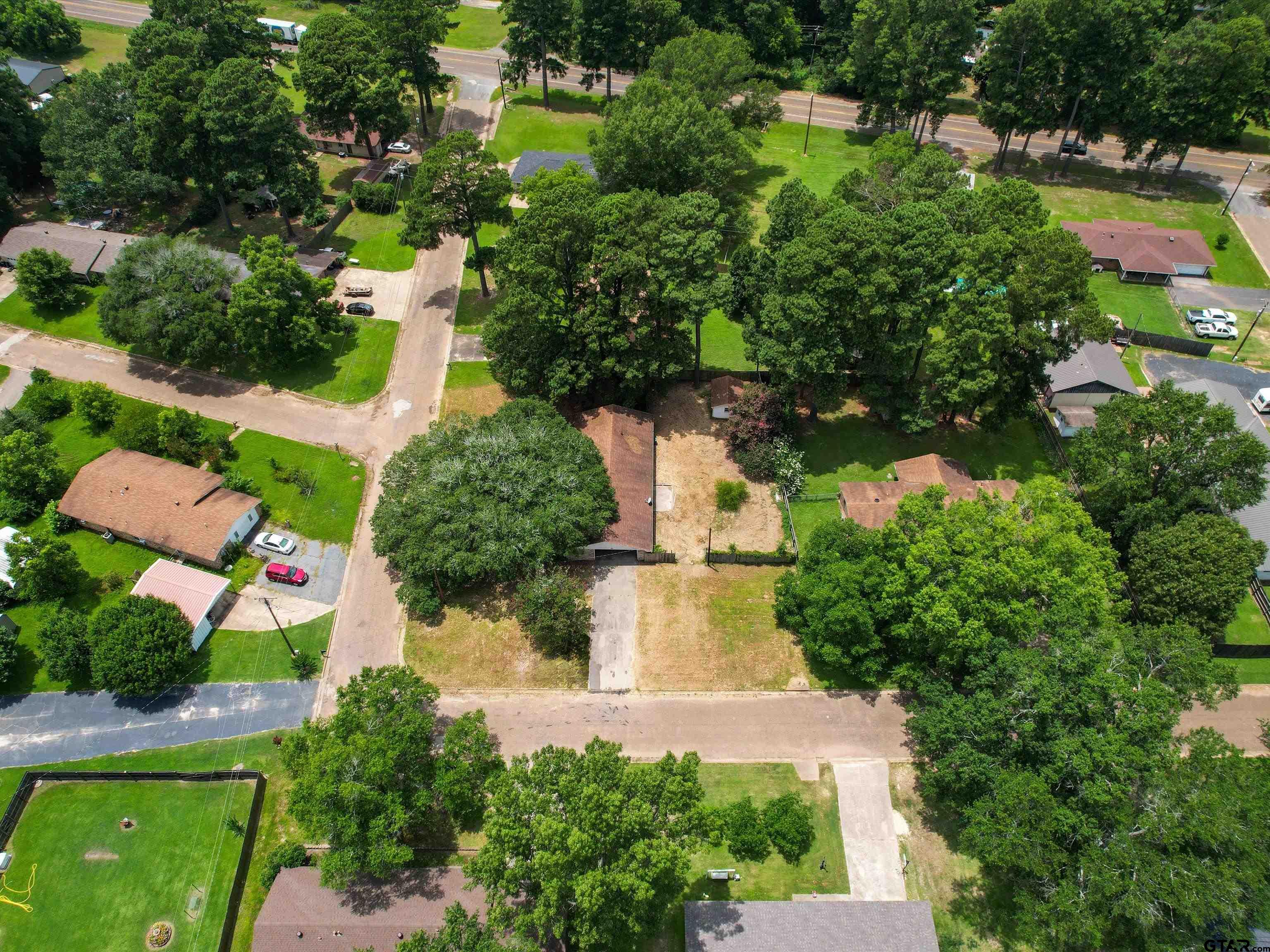 175 Stevens Street Gilmer, TX 75645 - Photo 7 of 25 an aerial view of residential house with outdoor space and swimming pool
