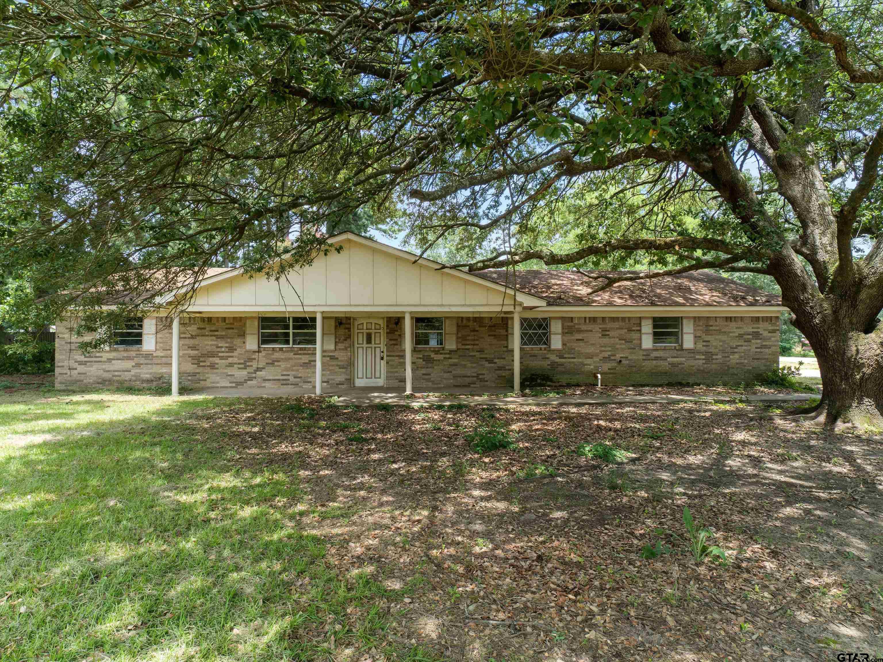 175 Stevens Street Gilmer, TX 75645 - Photo 9 of 25 a front view of a house with a garden