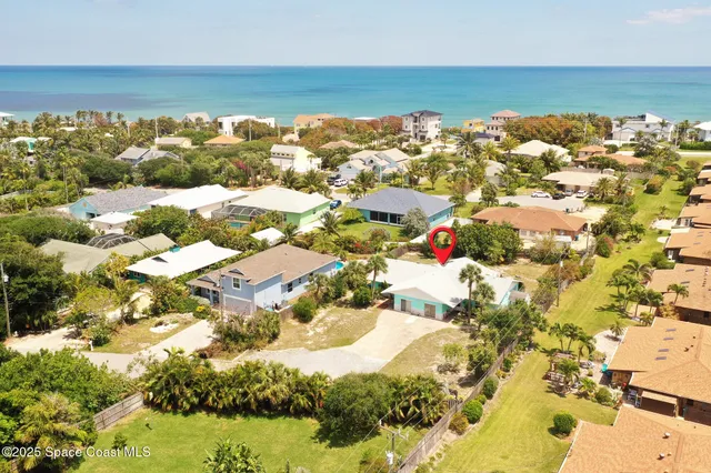 an aerial view of residential houses with outdoor space