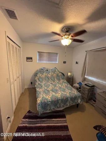 a large kitchen with a stove a refrigerator and a view of living room