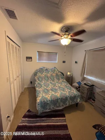 a large kitchen with a stove a refrigerator and a view of living room
