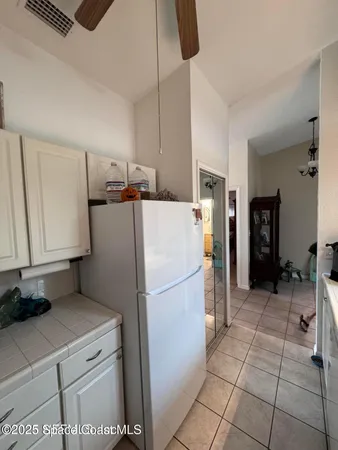 a hallway with a view of living room with furniture