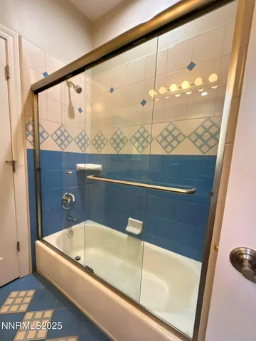 a bathroom with a bathtub and shower