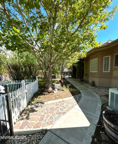 a view of a backyard with wooden fence