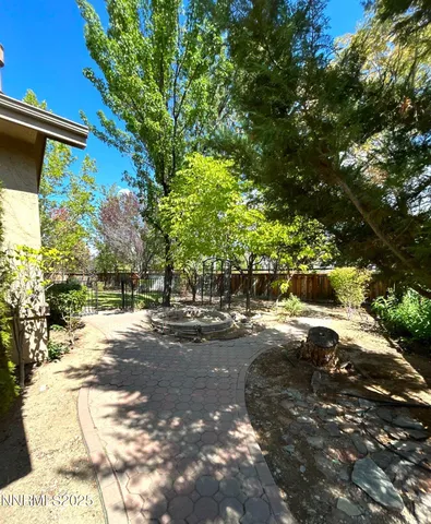 a backyard of a house with table and chairs