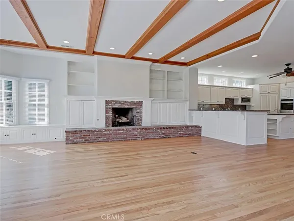 a view of a kitchen with cabinets and wooden floor