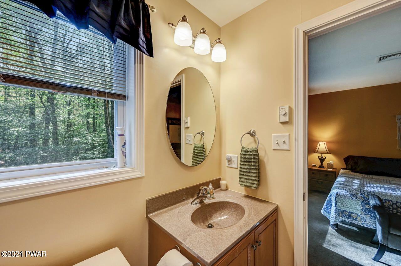 3295 Northgate Road Lake Ariel, PA 18436 - Photo 32 of 111 a bathroom with a sink and a mirror