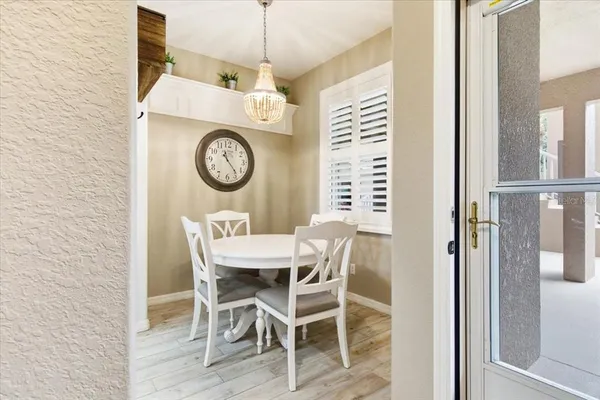 a living room with furniture a flat screen tv and a wall clock