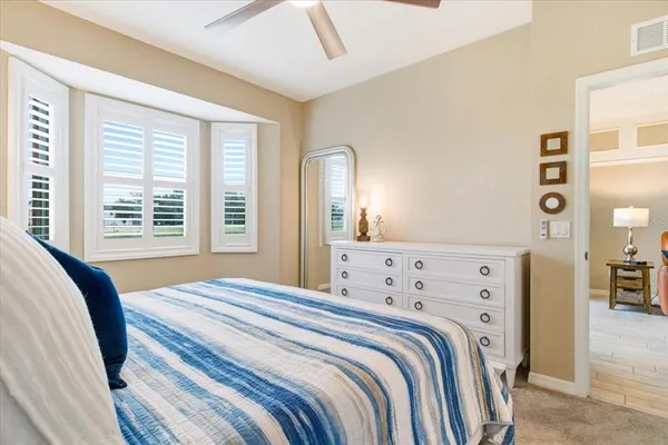 a bedroom with a bed and a mirror