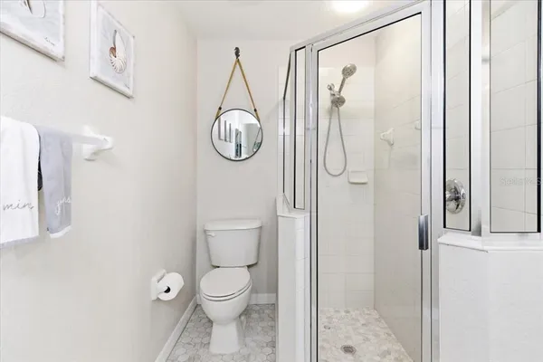 an aerial view of residential houses with outdoor space and lake view