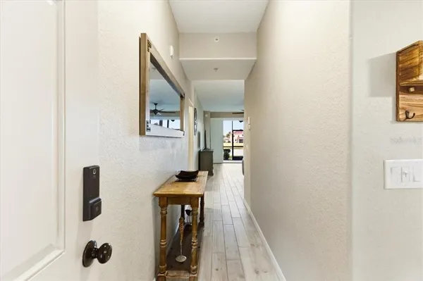 a kitchen with stainless steel appliances a refrigerator a table and chairs