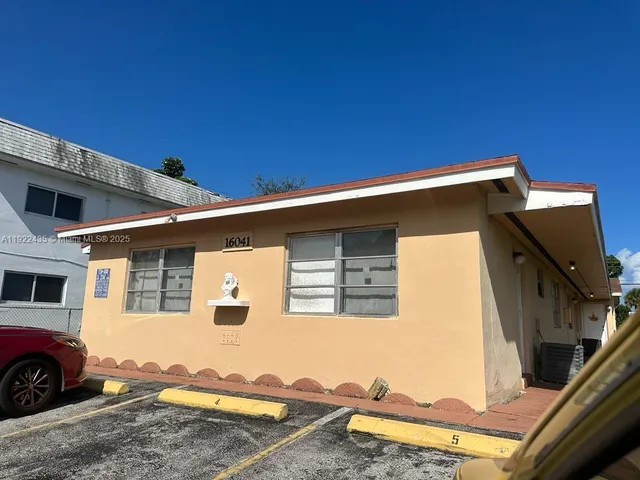 a front view of a house with parking space