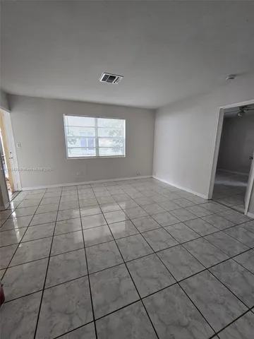 a view of an empty room and window