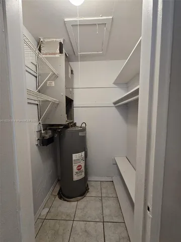 a utility room with a shower and cabinets