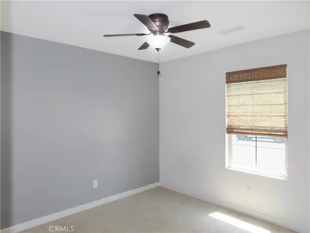 a small space with a window and a fan