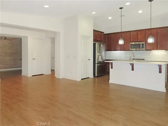 a kitchen with kitchen island granite countertop wooden cabinets and a sink
