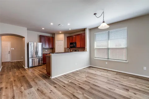 a view of a kitchen with a sink and a refrigerator