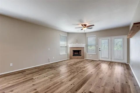 wooden floor in an empty room with a fireplace