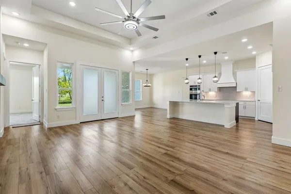 a view of kitchen and hall with wooden floor