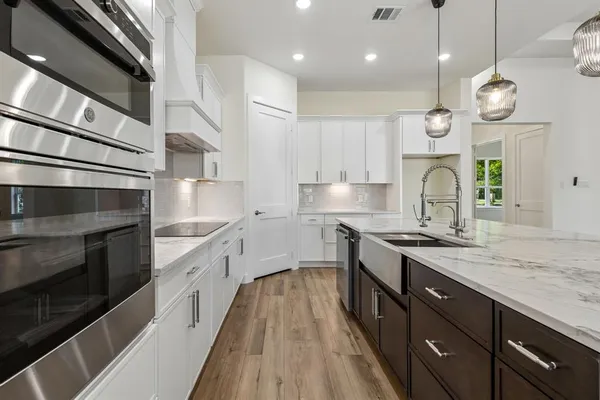 a kitchen with a sink stainless steel appliances and cabinets