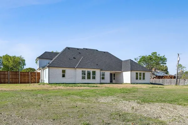 a view of a house next to a yard