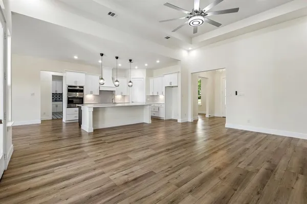 a view of kitchen with cabinets and wooden floor