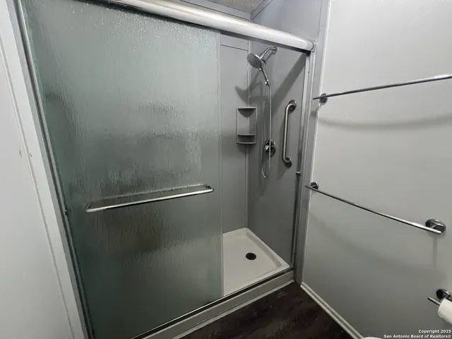a bathroom with a glass shower door