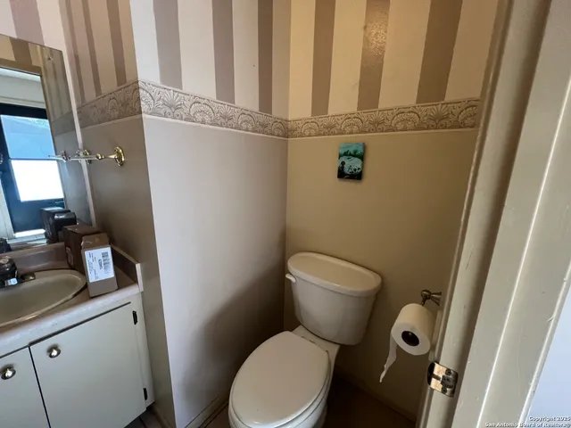 a white toilet sitting next to a sink